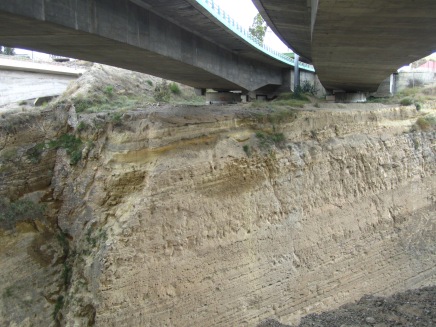 Earthquake dampers (the round things!) underneath the Corinth motorway bridge, with a small normal fault in the canal wall to the left of the bridge. Source: Gemma Smith